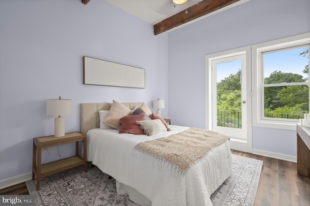 bedroom featuring beam ceiling, wood finished floors, baseboards, and access to outside