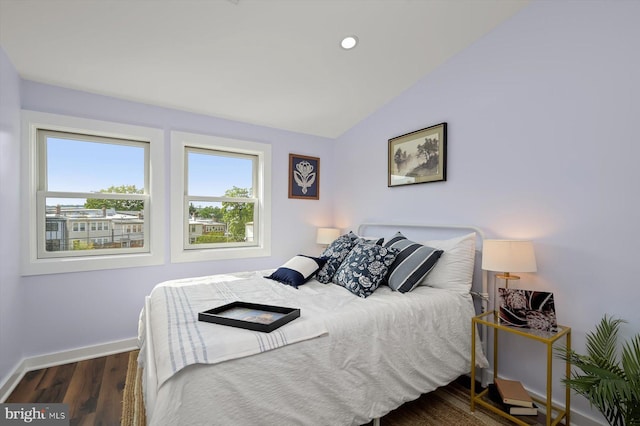 bedroom featuring baseboards, wood finished floors, vaulted ceiling, and recessed lighting