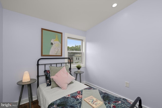 bedroom featuring baseboards, wood finished floors, and recessed lighting