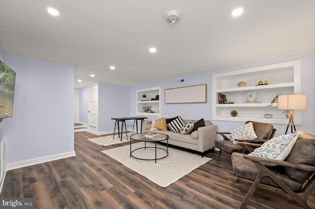 living area featuring built in shelves, baseboards, wood finished floors, and recessed lighting
