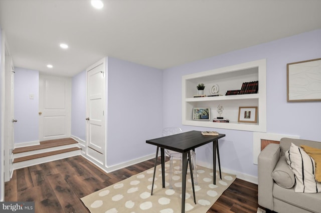 home office featuring dark wood finished floors, recessed lighting, baseboards, and built in shelves