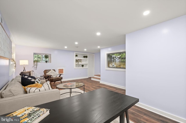 living room with dark wood-style flooring, baseboards, and recessed lighting