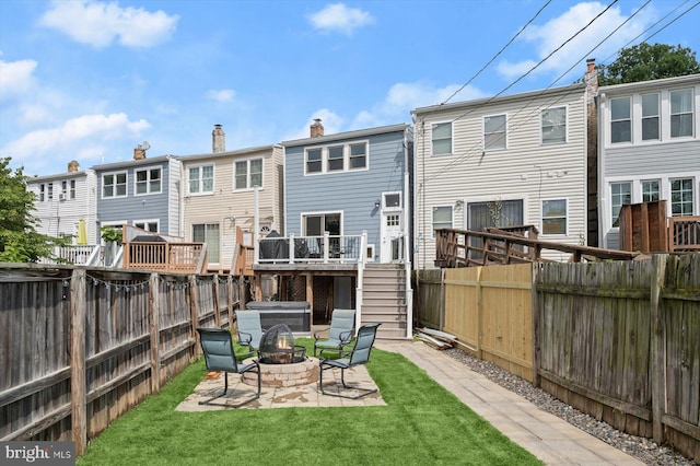 back of house featuring a fire pit, stairway, a patio, and a deck