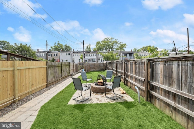 view of yard with an outdoor fire pit and a patio area