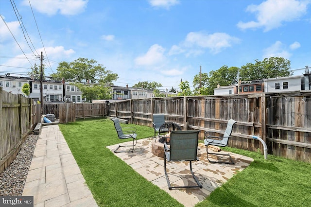 view of yard featuring a patio area and an outdoor fire pit