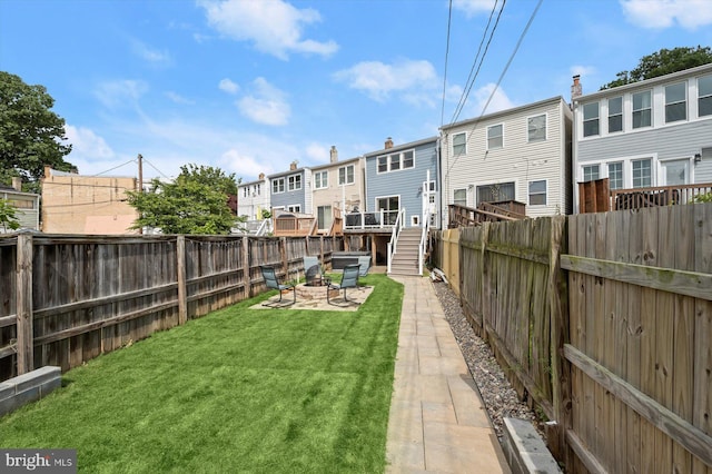view of yard with a fire pit, a residential view, and a patio area