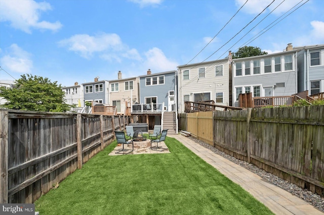 view of yard with an outdoor fire pit, a residential view, stairway, and a wooden deck
