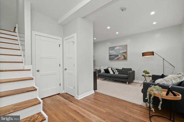 living area featuring stairway, light wood-type flooring, recessed lighting, and baseboards