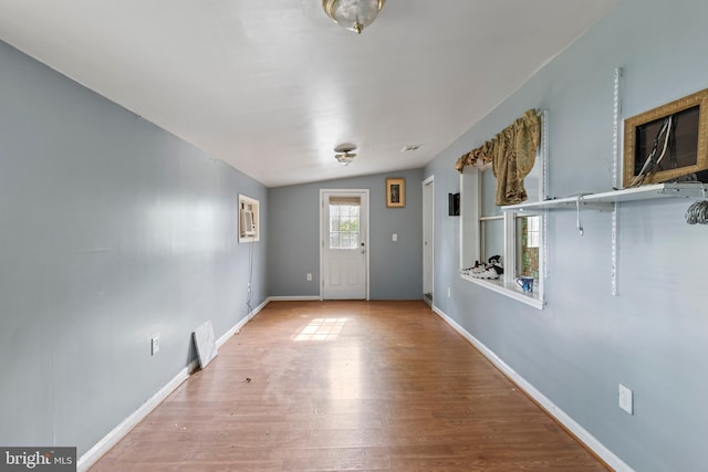 entryway with baseboards and wood finished floors