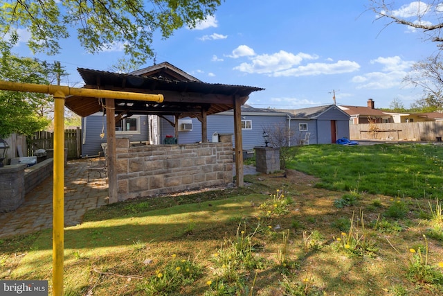 view of yard featuring fence and a gazebo