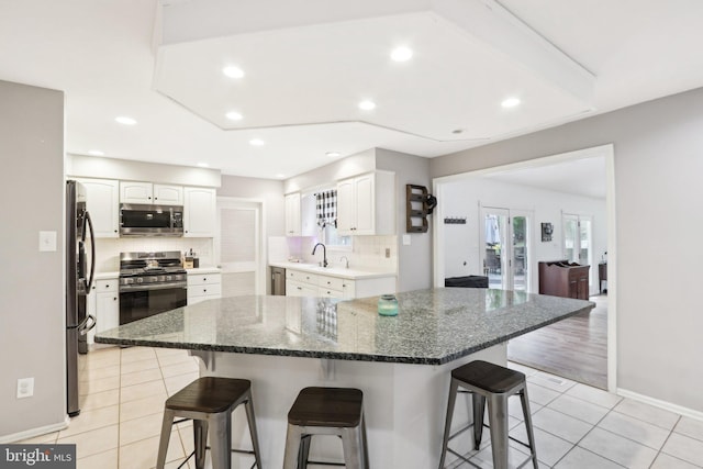 595 Tabernacle Rd, Medford, NJ 08055 - kitchen with stainless steel appliances, a breakfast bar area, tasteful backsplash, white cabinetry, and recessed lighting