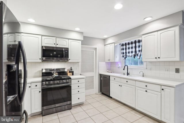 595 Tabernacle Rd, Medford, NJ 08055 - kitchen with appliances with stainless steel finishes, white cabinetry, tasteful backsplash, light countertops, and light tile patterned floors