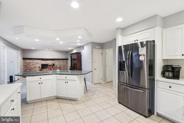 595 Tabernacle Rd, Medford, NJ 08055 - kitchen with stainless steel refrigerator with ice dispenser, a kitchen breakfast bar, recessed lighting, backsplash, and white cabinetry