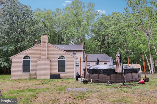 595 Tabernacle Rd, Medford, NJ 08055 - rear view of property featuring a chimney and view of scattered trees