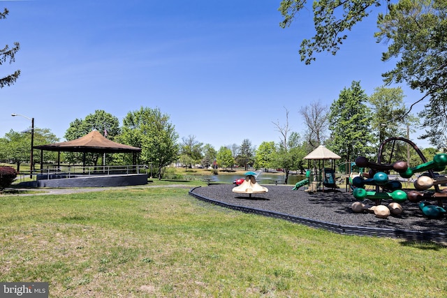 community jungle gym with a lawn and a gazebo