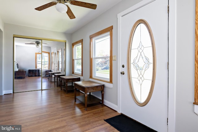 entrance foyer with baseboards, a ceiling fan, and wood finished floors