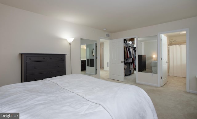 807 Anthony Dr, Harrisburg, PA 17111 - bedroom featuring a walk in closet, light colored carpet, connected bathroom, a closet, and baseboards