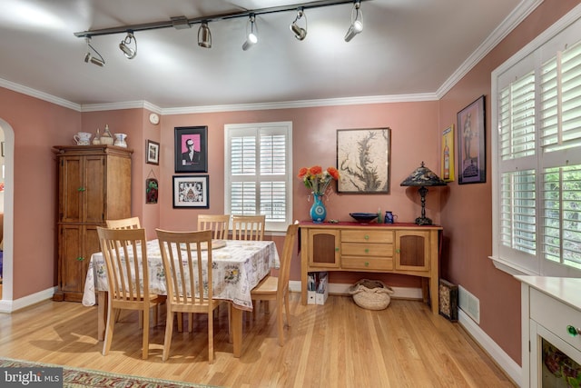263 Medwick Garth E, Baltimore, MD 21228 - dining room with light wood finished floors, arched walkways, baseboards, ornamental molding, and rail lighting