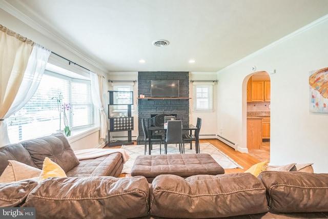10918 Allen Ave, Hagerstown, MD 21740 - living room featuring visible vents, arched walkways, light wood finished floors, and crown molding
