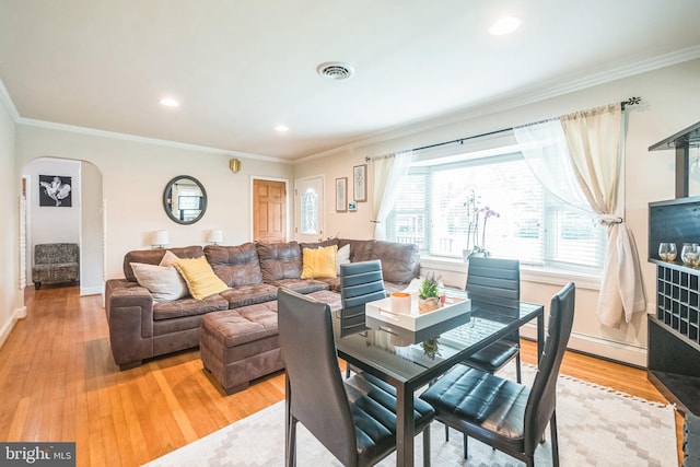 10918 Allen Ave, Hagerstown, MD 21740 - dining area with arched walkways, baseboards, visible vents, and light wood-style flooring