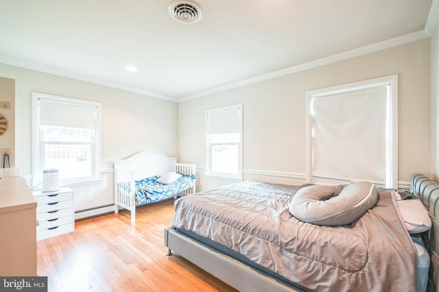 10918 Allen Ave, Hagerstown, MD 21740 - bedroom featuring a baseboard heating unit, ornamental molding, visible vents, and light wood-type flooring