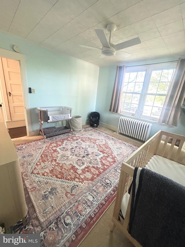 bedroom with a ceiling fan and baseboards