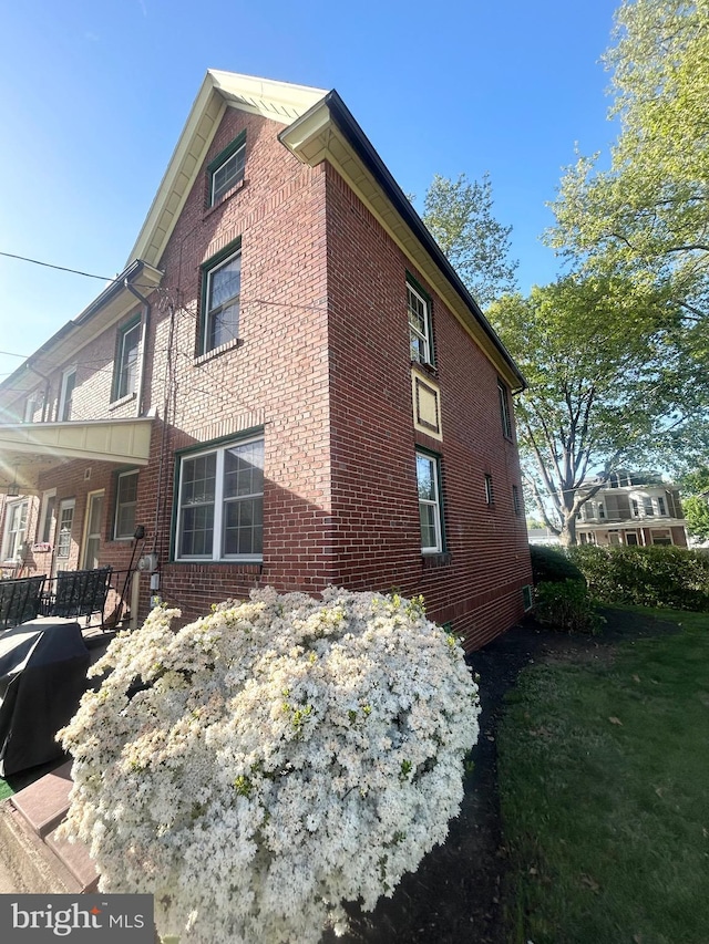 view of side of home with brick siding