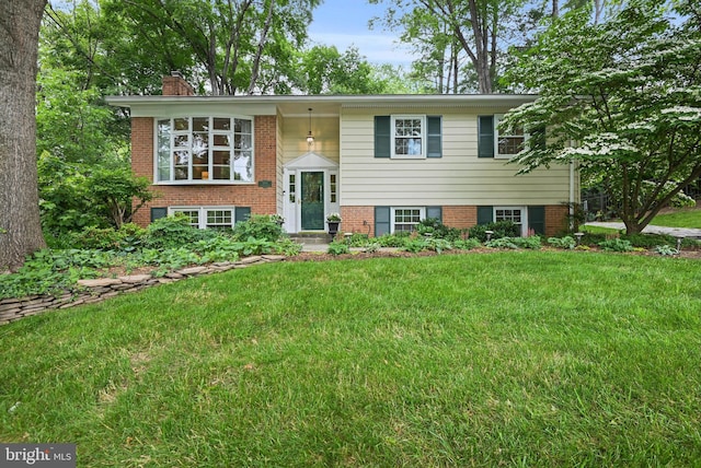 503 Colony Ct NW, Vienna, VA 22180 - split foyer home with a chimney, a front lawn, and brick siding