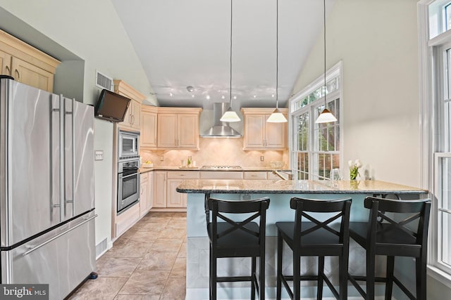 503 Colony Ct NW, Vienna, VA 22180 - kitchen with stainless steel appliances, wall chimney exhaust hood, light brown cabinets, tasteful backsplash, and light stone counters