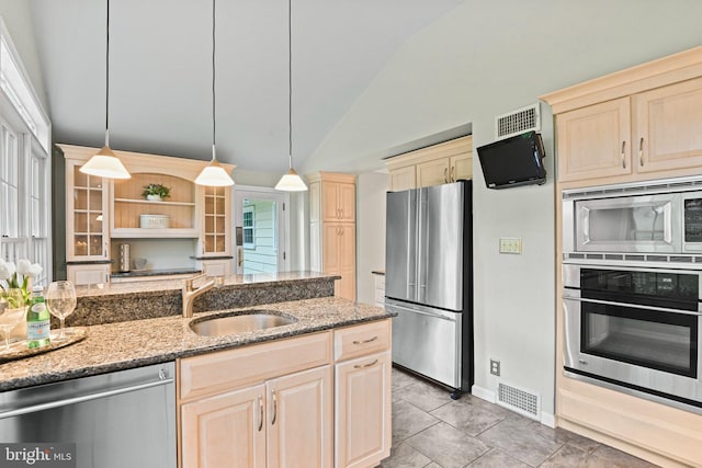 503 Colony Ct NW, Vienna, VA 22180 - kitchen featuring stainless steel appliances, a sink, lofted ceiling, light stone counters, and decorative light fixtures