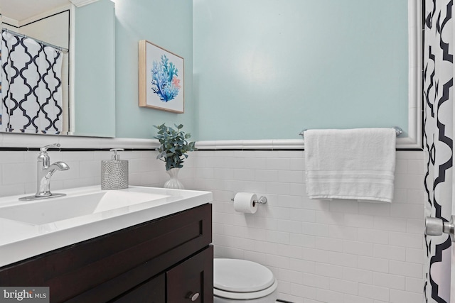 503 Colony Ct NW, Vienna, VA 22180 - bathroom featuring vanity, toilet, tile walls, curtained shower, and wainscoting
