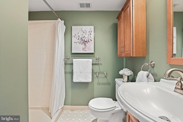 503 Colony Ct NW, Vienna, VA 22180 - bathroom featuring a sink, toilet, a stall shower, and baseboards