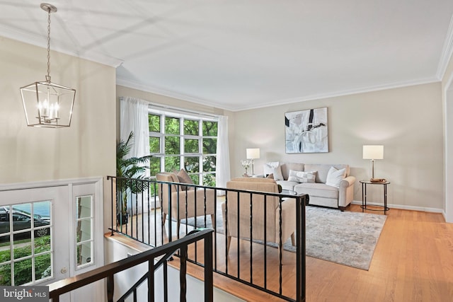 503 Colony Ct NW, Vienna, VA 22180 - living area with ornamental molding, a chandelier, wood finished floors, and baseboards