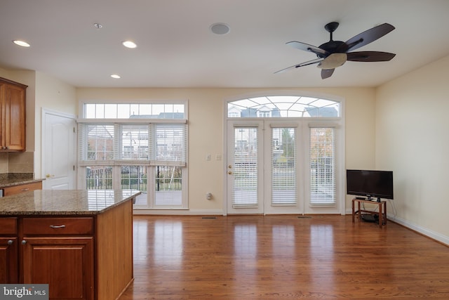 doorway with recessed lighting, a ceiling fan, baseboards, and wood finished floors