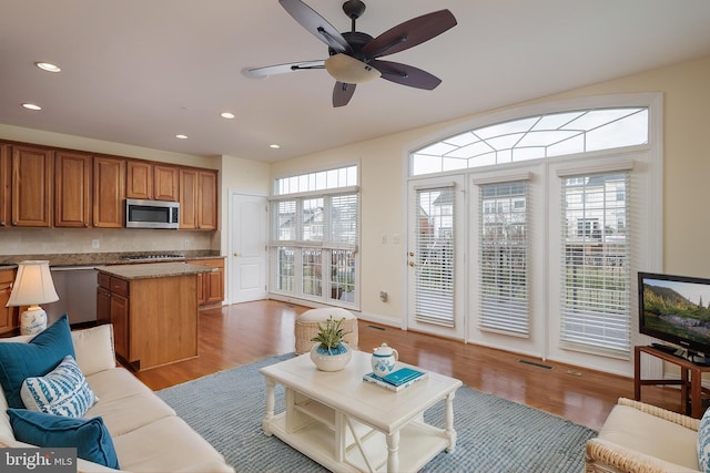 living room featuring recessed lighting, ceiling fan, wood finished floors, and visible vents