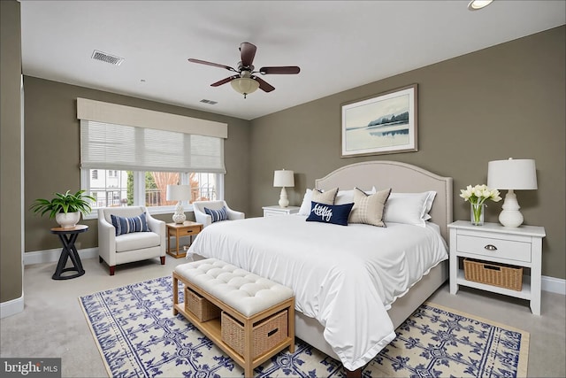 carpeted bedroom with a ceiling fan, baseboards, and visible vents