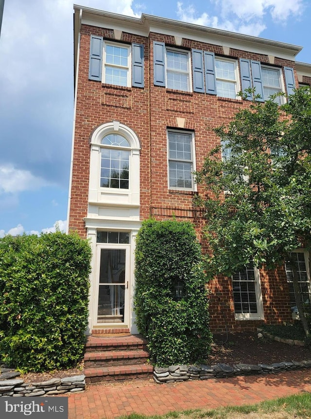 multi unit property with brick siding and entry steps
