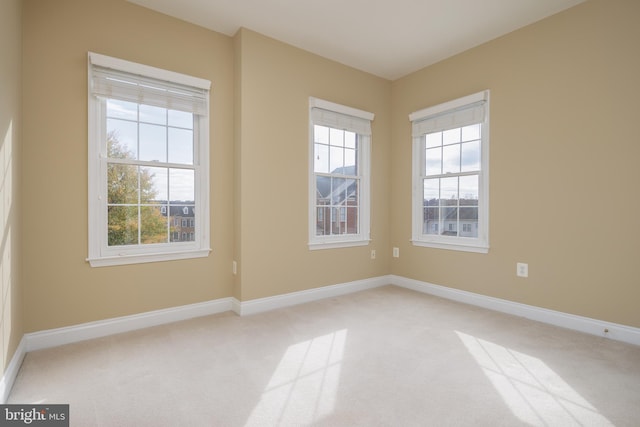 empty room with carpet floors and baseboards