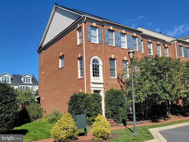 exterior space featuring brick siding