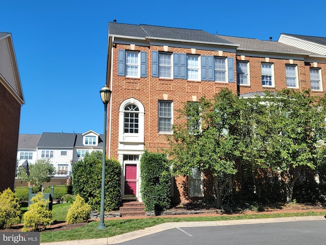 townhome / multi-family property featuring brick siding