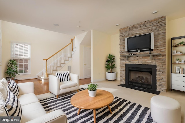 living area with stairway, baseboards, a fireplace, and visible vents