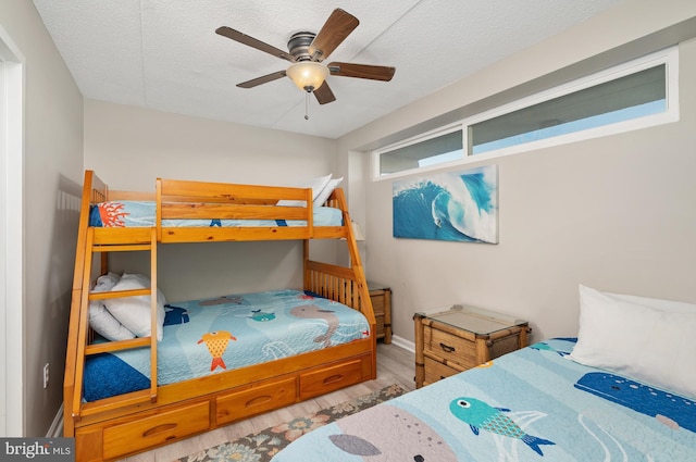 4711 Coastal Hwy Unit 441, Ocean City, MD 21842 - bedroom featuring baseboards, a ceiling fan, a textured ceiling, and wood finished floors