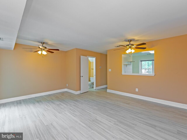 unfurnished living room featuring baseboards, ceiling fan, and light wood-type flooring
