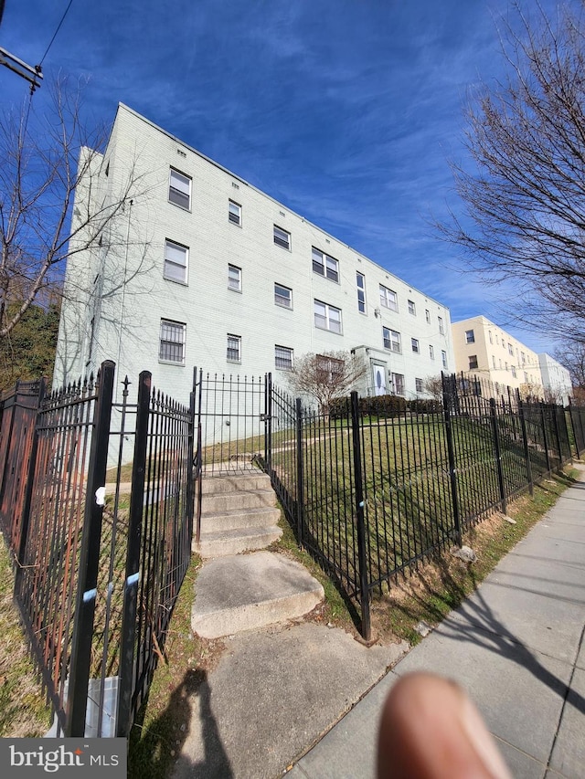 4800 C St SE Unit 104, Washington, DC 20019 - view of home's exterior with a fenced front yard