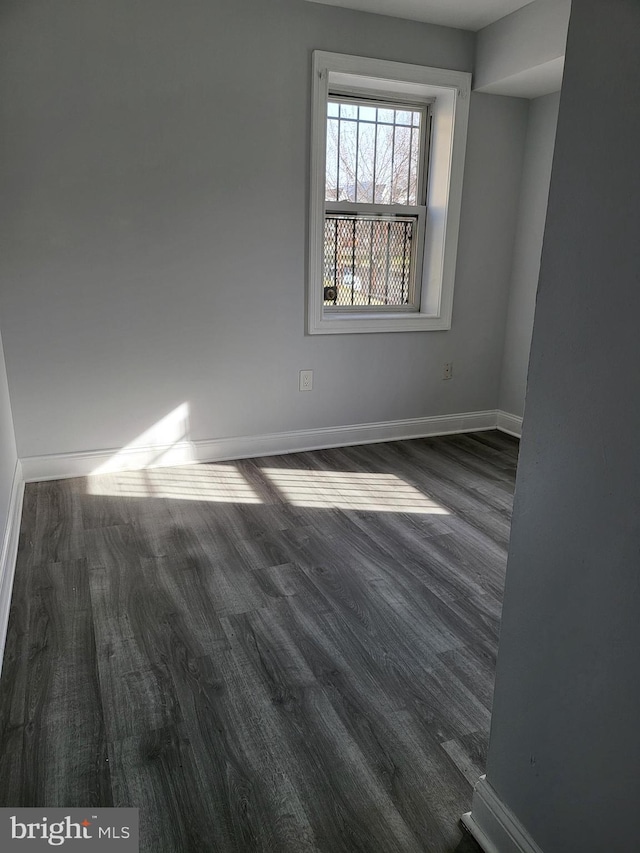 4800 C St SE Unit 104, Washington, DC 20019 - unfurnished room with baseboards and dark wood-type flooring