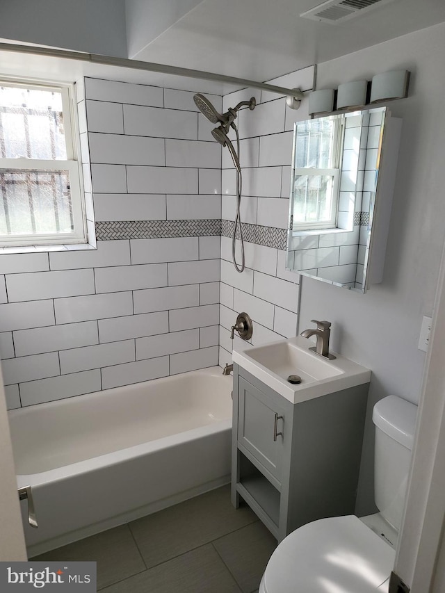 bathroom featuring vanity, tile patterned floors, a wealth of natural light, and toilet