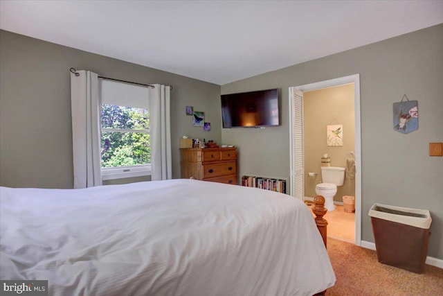 bedroom featuring carpet floors, baseboards, and connected bathroom
