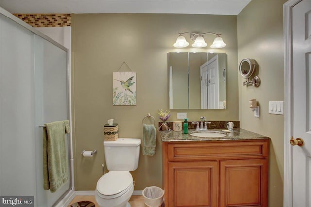 bathroom with vanity, a stall shower, and toilet