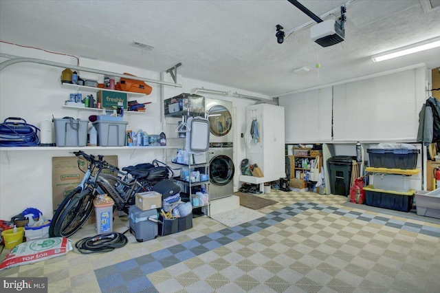 garage with a garage door opener and stacked washer and dryer