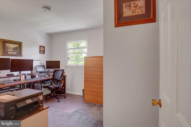 carpeted office space featuring baseboards and visible vents